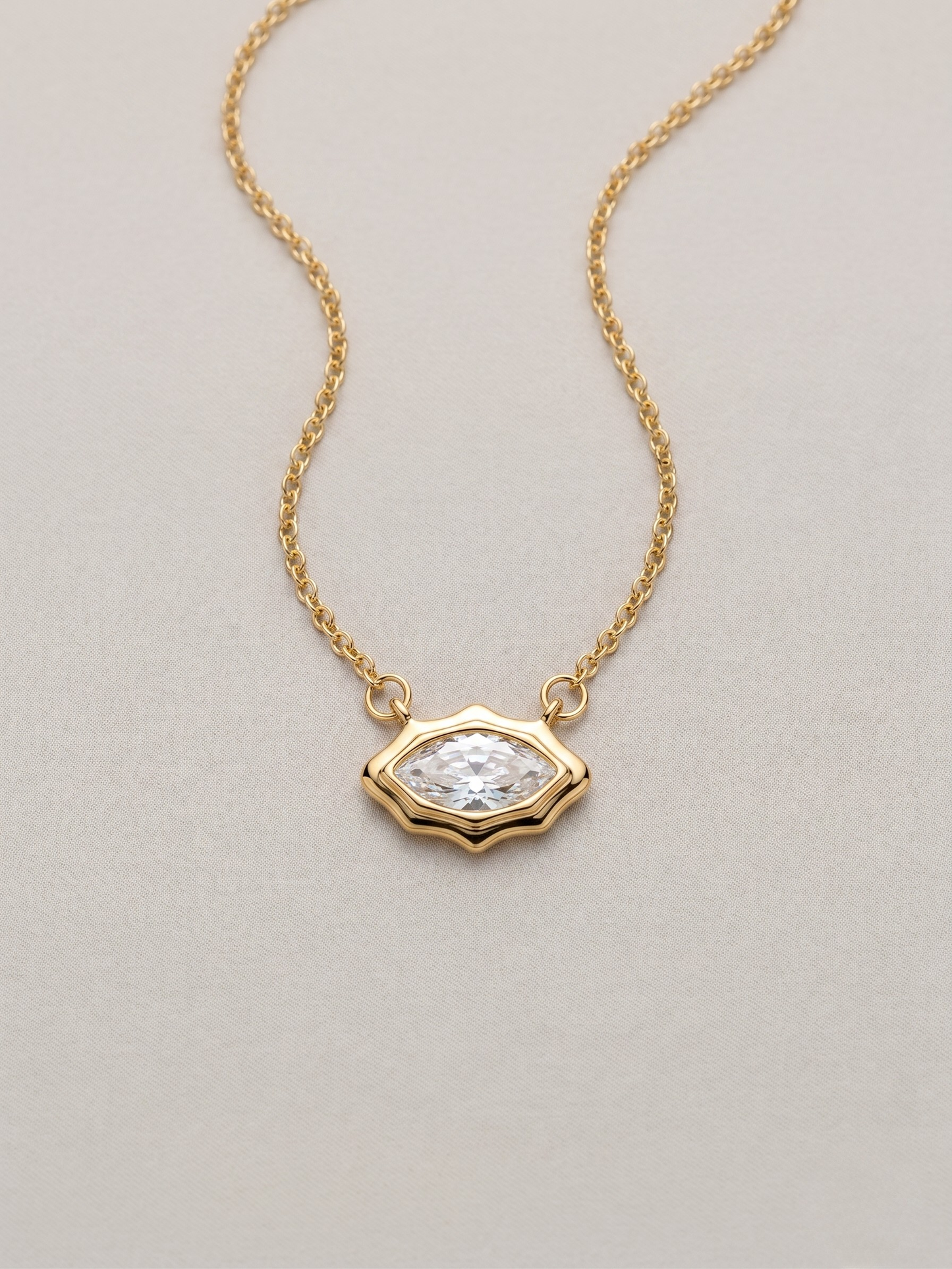 Gold pendant necklace with a marquis cut stone