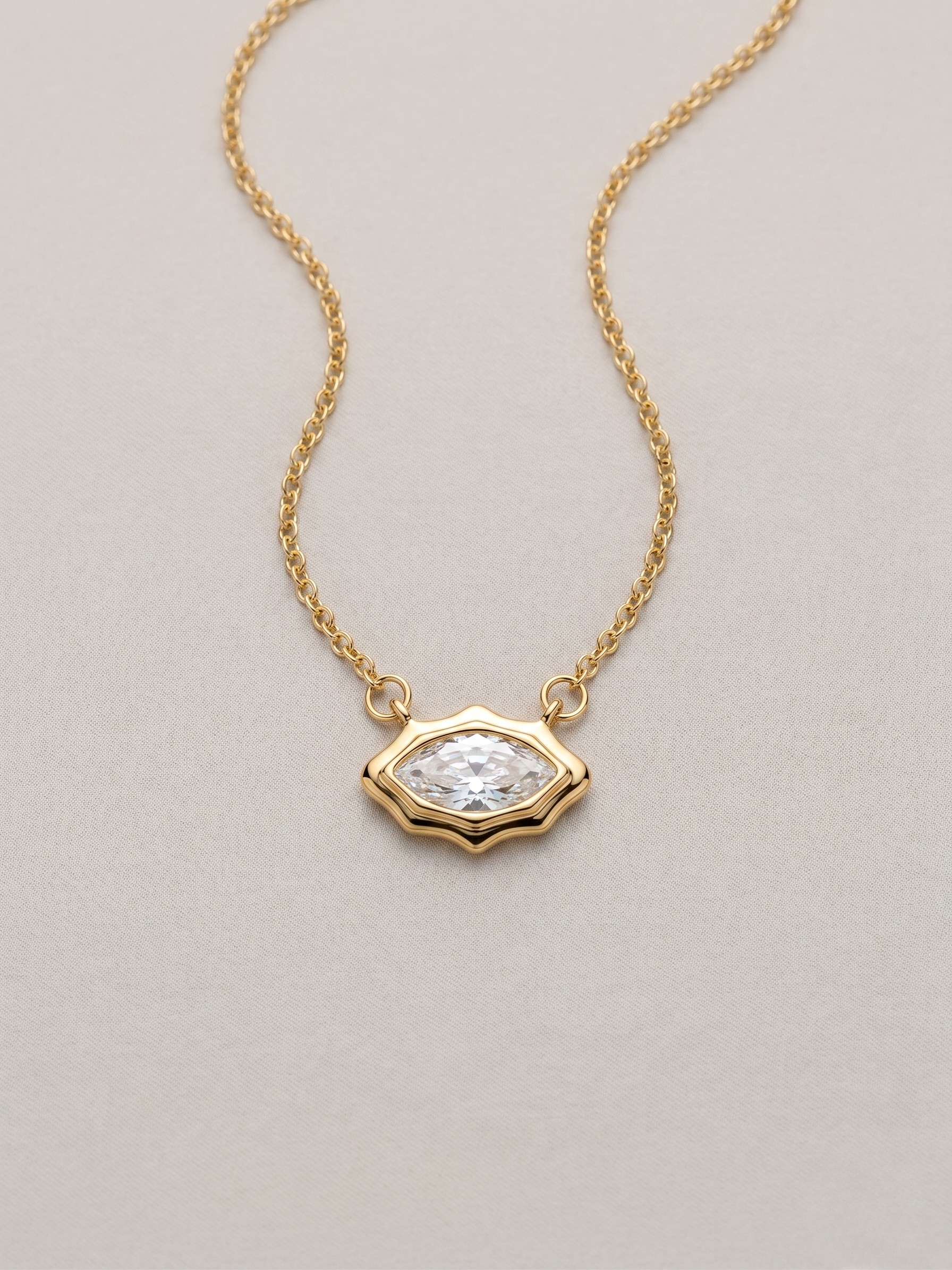 Gold pendant necklace with a marquis cut stone